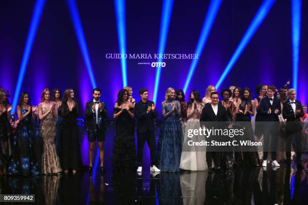 Designer Guido Maria Kretschmer and models acknowledge the applause of the audience the runway during the Guido Maria Kretschmer Fashion Show...