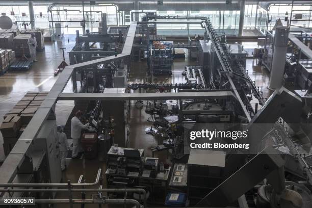 Employees work on the production line at the Natura Cosmeticos SA production facility in the town of Cajamar, Sao Paulo State, Brazil, on Wednesday,...