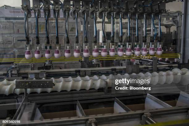 Bottles of lotions move through the production line at the Natura Cosmeticos SA production facility in the town of Cajamar, Sao Paulo State, Brazil,...