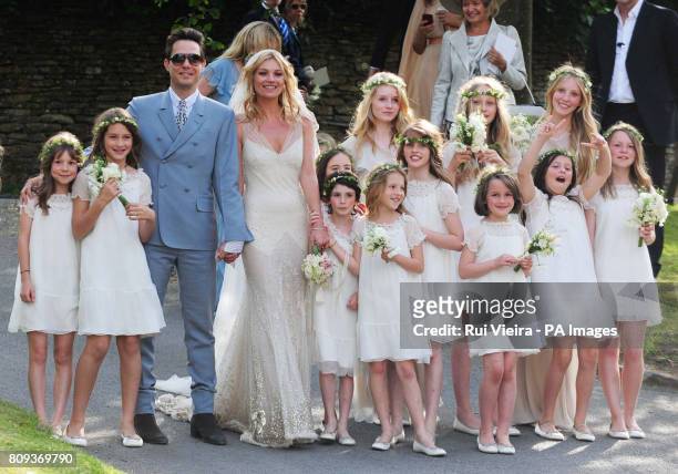 Kate Moss with her new husband Jamie Hince pose with bridesmaids after their wedding at St Peter's Church in Southrop.