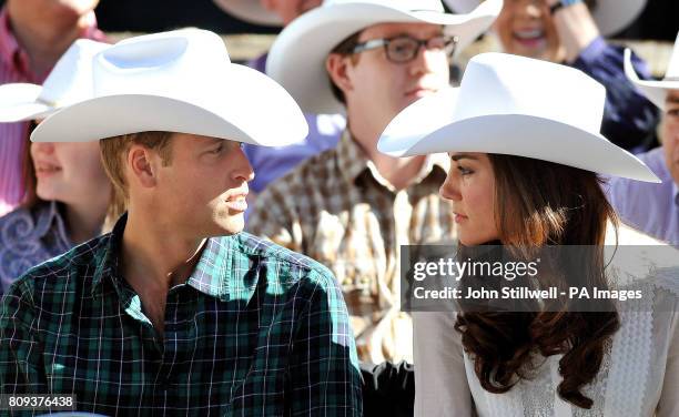 The Duke and Duchess of Cambridge wear matching a Stetson hat as they view the start of the Calgary Stampede parade in western Canada.