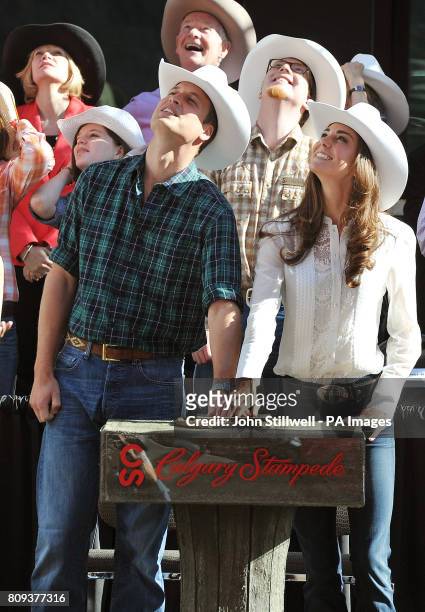 The Duke and Duchess of Cambridge press a button to launch fireworks and officially start the Calgary Stampede parade in western Canada.