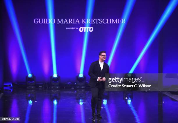 Designer Guido Maria Kretschmer acknowledges the applause of the audience the runway during the Guido Maria Kretschmer Fashion Show Autumn/Winter...