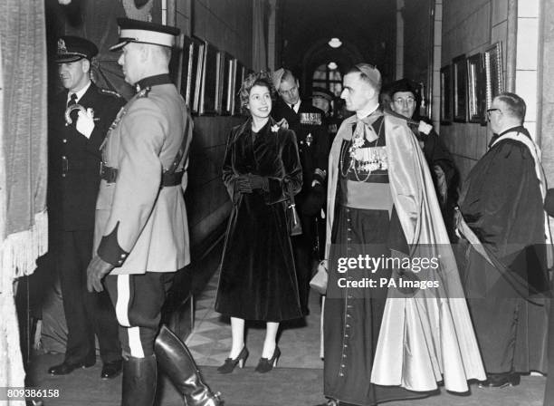 Princess Elizabeth walks with a Catholic clergyman during the tour of Laval University, Quebec City.