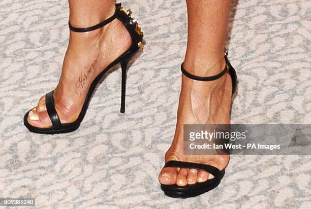 Jennifer Aniston's new tattoo seen at a photocall for their new film Horrible Bosses, at the Dorchester Hotel in London.