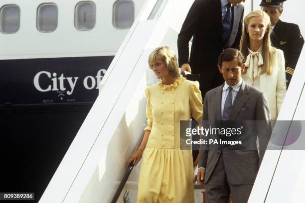 The Prince and Princess of Wales step from a jumbo jet at Heathrow Airport following a flight from Miami. They had returned from a 10 day holiday in...