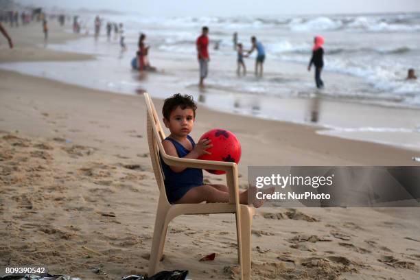 Palestinians swim in the sea at sunset in Gaza City on July 5, 2017. The Palestinian Environment Quality Authority said in a statement that the...