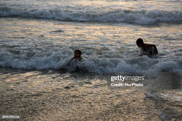 Palestinians swim in the sea at sunset in Gaza City on July 5, 2017. The Palestinian Environment Quality Authority said in a statement that the...