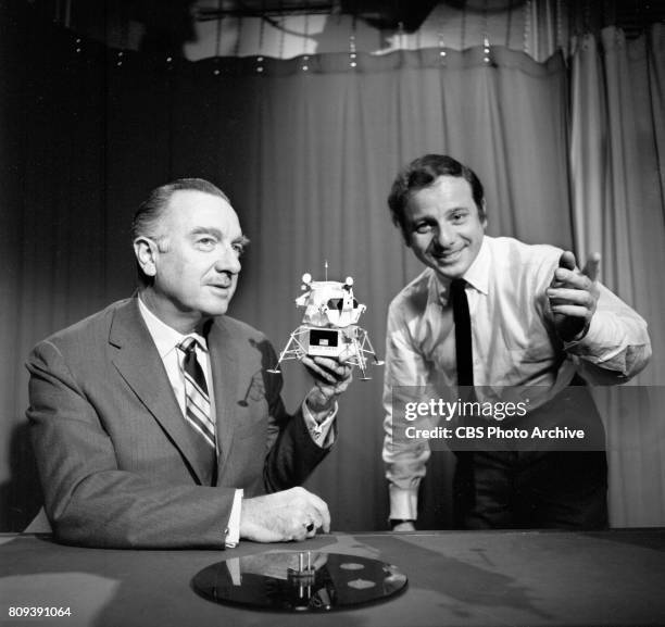 News anchor Walter Cronkite, at left, with a scale model of the Apollo 11 lunar module. At right is CBS News director Fred Stollmack. Image dated...