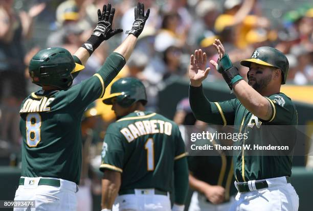 Jed Lowrie and Yonder Alonso of the Oakland Athletics celebrates after they both scored against the Chicago White Sox in the bottom of the third...