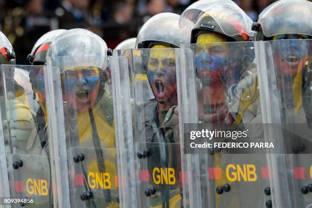 Venezuelan National Guard personnel in riot gear take part in a parade to celebrate Venezuela's 206th anniversary of its Independence in Caracas on...