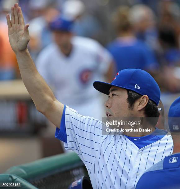 Koji Uehara of the Chicago Cubs greets teammates in the dugout after pitching in the 8th inning against the Tampa Bay Rays at Wrigley Field on July...