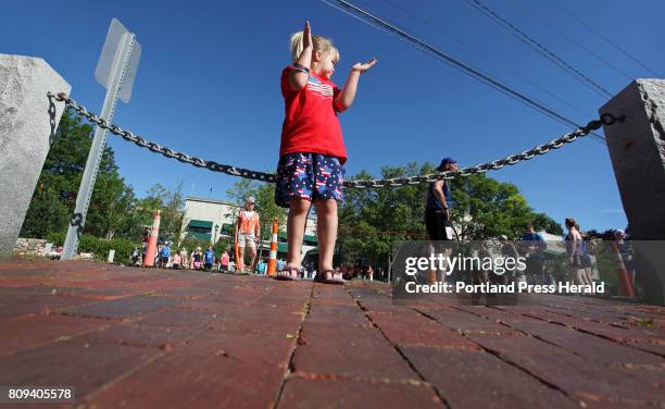 Cassidy Morrell of Windham cheers for finishers at the L.L. Bean Fourth of July 10K. Cassidys mom, Sara, competed in the race.