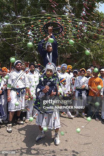 Indian Sikh youths perform Gatka-a Sikh martial art-as they take part with others in a procession escorting the Palki Sahib from the Lohgarh Sahib...