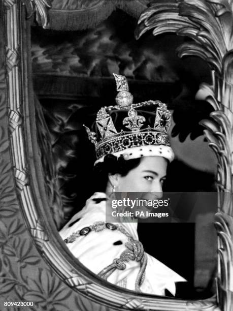 Queen Elizabeth II gives a wide smile for the crowd from her carriage as she leaves Westminster Abbey, London after her Coronation.