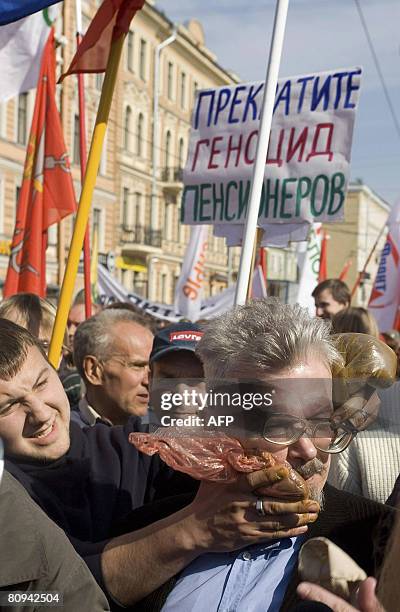 An assailant shoves plastic bags filled with feces into the face "The Other Russia" opposition politician and counter-cultural writer Eduard Limonov...