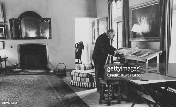 British statesman Winston Churchill at home in the study of his Chartwell estate in Kent, . Most of his work is done standing up at a desk specially...