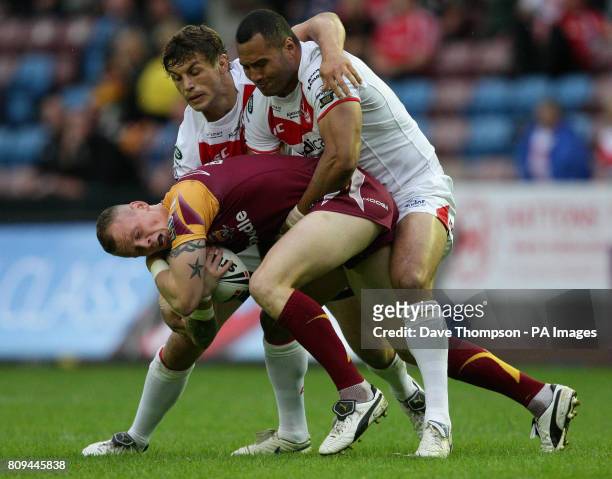 St Helens' Jon Wilkin and Francis Meli tackle Huddersfield Giants' Kevin Brown during the engage Super League match at the Stobart Stadium, Widnes.