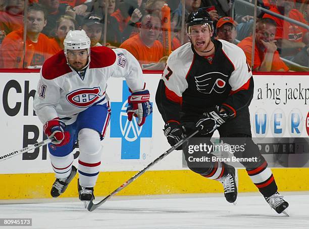 Jeff Carter of the Philadelphia Flyers skates against Francis Bouillon of the Montreal Canadiens during game three of the Eastern Conference...