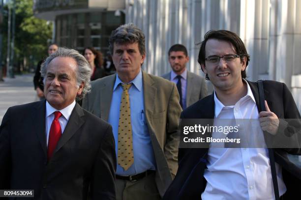 Martin Shkreli, former chief executive officer of Turing Pharmaceuticals AG, right, exits federal court with his attorney Benjamin Brafman, left, in...