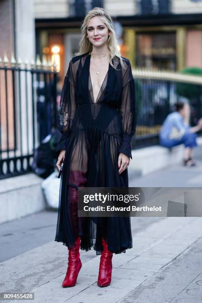 Chiara Ferragni wears a black lace mesh dress, and thigh high red leather boots, before the Fendi show, during Paris Fashion Week - Haute Couture...