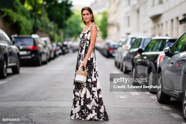 Gala Gonzalez wears a black and white dress, and a straw bag, outside the Valentino show, during Paris Fashion Week - Haute Couture Fall/Winter...
