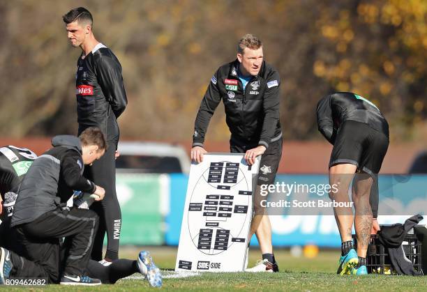 Nathan Buckley, coach of the Magpies and Scott Pendlebury, captain of the Magpies look on during a Collingwood AFL training session at the Holden...