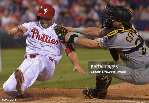 Daniel Nava of the Philadelphia Phillies gets tagged out at home plate by Francisco Cervelli of the Pittsburgh Pirates in the seventh inning at...