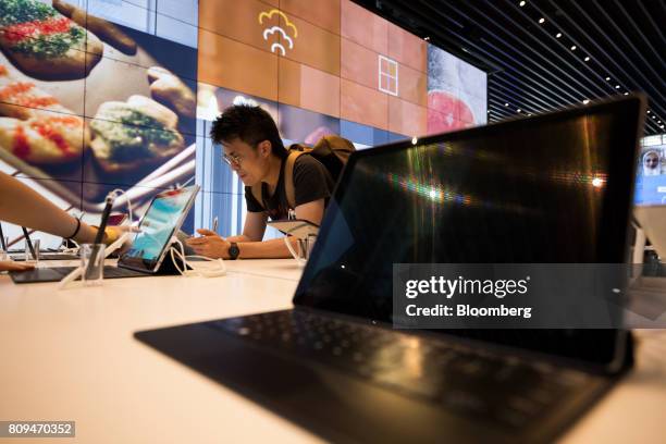 Customer tries a Samsung Electronics Co. Galaxy Tab tablet device at the company's D'light flagship store in Seoul, South Korea, on Wednesday, July...