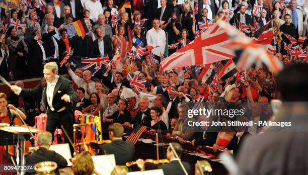 Edward Gardner conducts the BBC Symphony Orchestra at the Royal Albert Hall, as the crowds wave flags as they sing Land of Hope and Glory, during the...