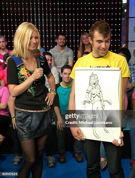 Actress Gwyneth Paltrow is shown a drawing of her as "Super Mom" on MTV's "TRL" at MTV Studios in New York City's Times Square on April 28, 2008. The...