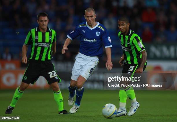 Cardiff City's Kenny Miller skips away from challenge by Brighton and Hove Albion's Liam Bridcutt during the npower Championship match at Cardiff...