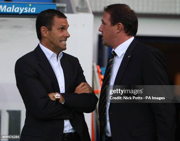 Brighton and Hove Albion Manager Gus Poyet talks with Cardiff City Manager Malky Mackay ahead of the npower Championship match at Cardiff City...