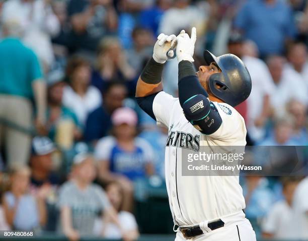 Nelson Cruz of the Seattle Mariners celebrates his solo home run in the third inning against starting pitcher Jason Vargas of the Kansas City Royals...