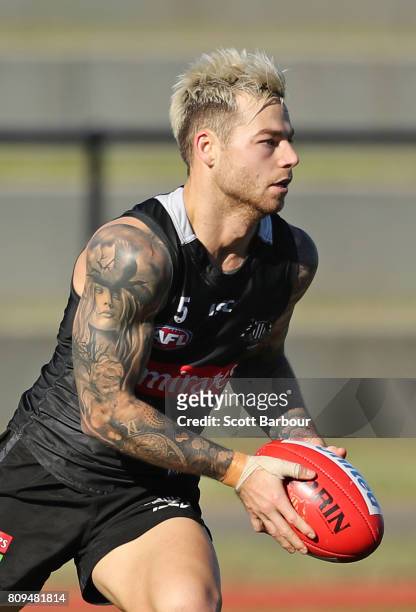 Jamie Elliott of the Magpies runs with the ball during a Collingwood AFL training session at the Holden Centre on July 6, 2017 in Melbourne,...