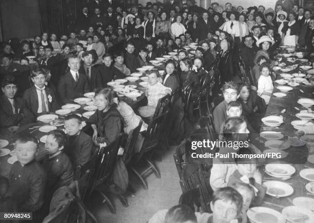 The children of striking workers in Lawrence, Massachusetts, are provided with food at the Labor Temple in New York City, during the Lawrence Textile...