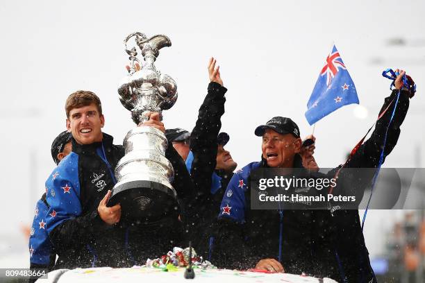 Peter Burling and Grant Dalton celebrate with the Americas Cup during the Team New Zealand Americas Cup Welcome Home Parade on July 6, 2017 in...