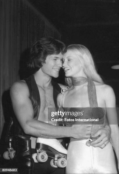 American actor Patrick Swayze shares a laugh with his wife, dancer and actress Lisa Niemi at the premiere party for the movie 'Skatetown USA' at...
