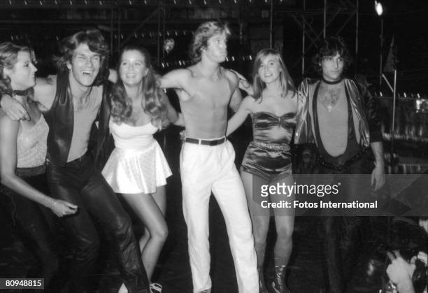 From left, American actors April Allen, Patrick Swayze, Katherine Kelly Lang, Greg Bradford, Maureen McCormick, and Len Bari stand arm in arm during...