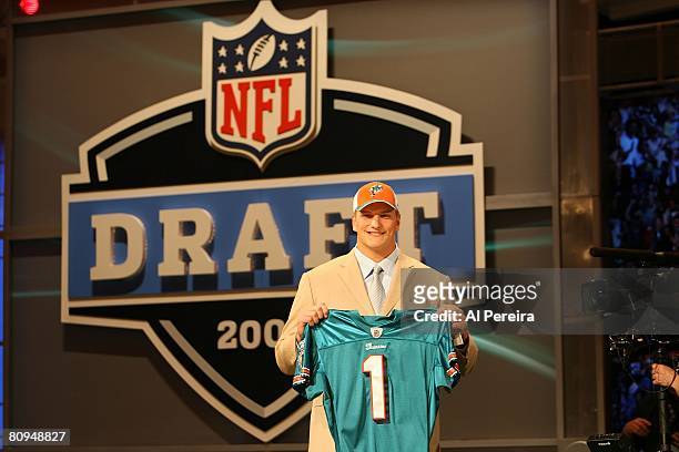 Offensive Tackle Jake Long of Michigan holds up a jersey after being selected by the Miami Dolphins with the No.1 overall pick of the 2008 National...
