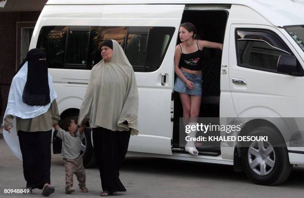 Russian girl stands in a minibus outside the hospital in Suez 135 km northeast Cairo on May 1 after being treated for injuries she sustained in a bus...