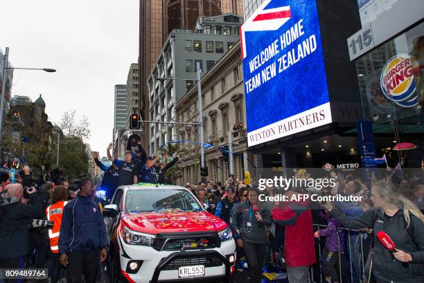 Members of the Emirates Team New Zealand parade the America's Cup yachting trophy through the streets of Auckland on July 6, 2017. Team New Zealand...