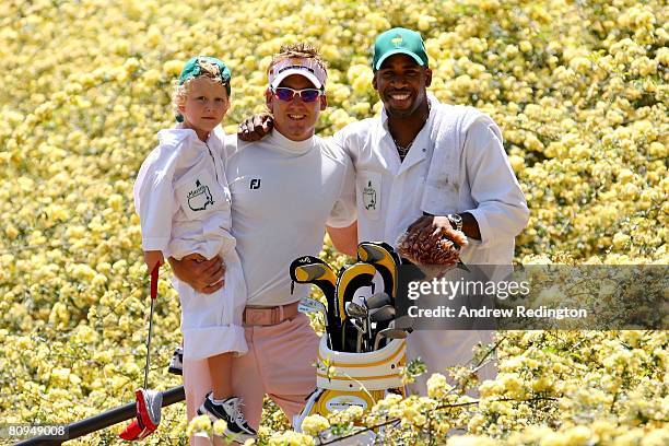 Jonathan Joseph, aka DJ Spoony poses with Ian Poulter of England and Ian's son Luke James during the Par 3 Contest during the third day of practice...