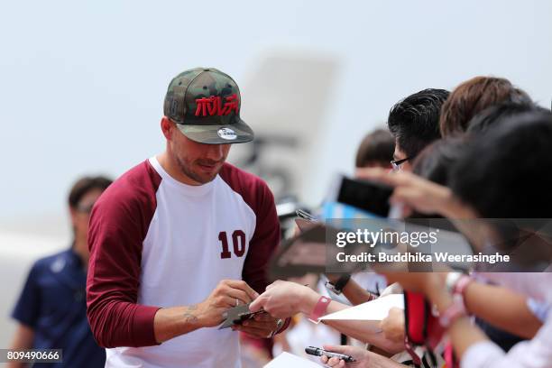Vissel Kobe new player Lukas Podolski signs an autograph for his Japanese football fans during the welcome ceremony at the Kobe Airport on July 6,...