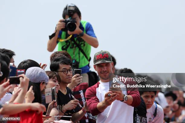 Vissel Kobe new player Lukas Podolski takes selfie with Japanese football fans during the welcome ceremony at the Kobe Airport on July 6, 2017 in...