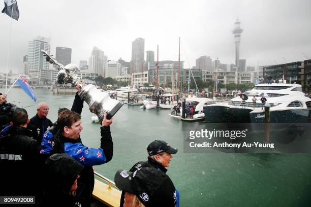 Peter Burling, helmsman of Emirates Team New Zealand showcases the America's Cup trophy to the supporters during the Team New Zealand Americas Cup...