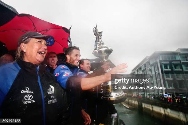 Blair Tuke, cyclist/foil trimmer of Emirates Team New Zealand showcases the America's Cup trophy to the supporters during the Team New Zealand...