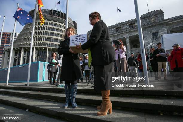 Green Party co-leader Metiria Turei receives a petition from organiser Anneleise Hall at Parliament on July 6, 2017 in Wellington, New Zealand. The...