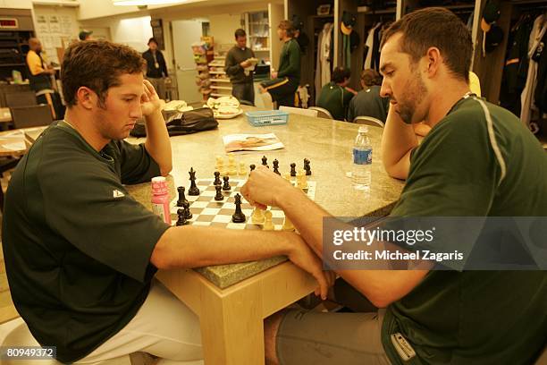 Huston Street and Andrew Brown of the Oakland Athletics play chess in the locker room before the game against the Boston Red Sox at the McAfee...