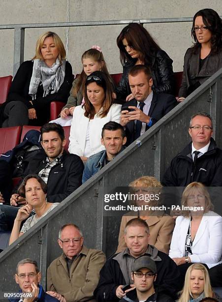 New Queens Park Rangers' signing Joey Barton watches from the stands during the Barclays Premier League match at the DW Stadium, Wigan.